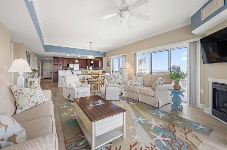 Spacious Seaside-themed Living Space With Broad Windows, Breezy Blues, And Beach Motifs In Vacation Rental