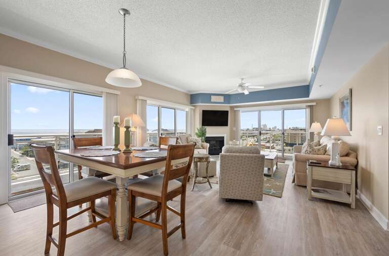 Brightly-lit Room With Dining Set And Seating Area Overlooking Coastal Views