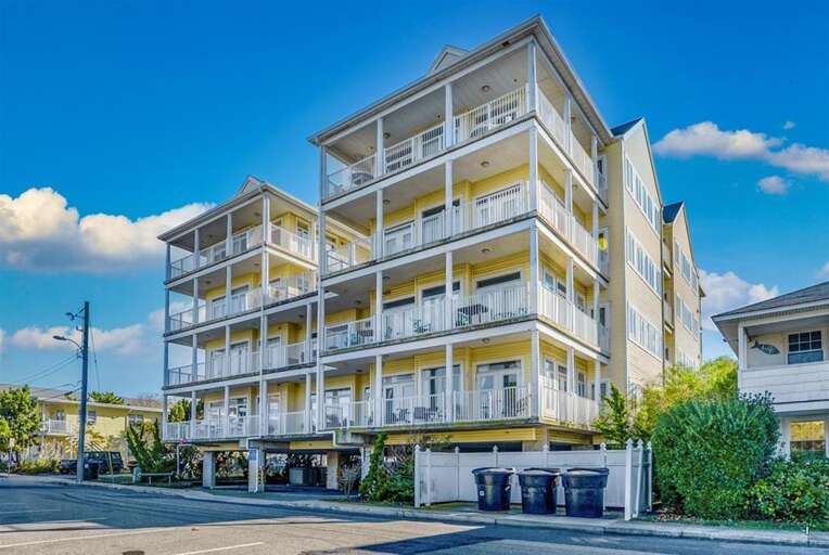 Multi-level Building With Balconies Under Blue Sky