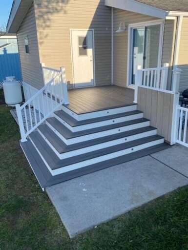 White Wooden Steps Leading To Gray-sided Structure With Porch