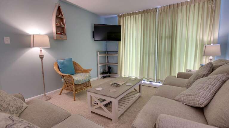 Peaceful Living Area In Vacation Rental With Pastel Palette And Plush Seating