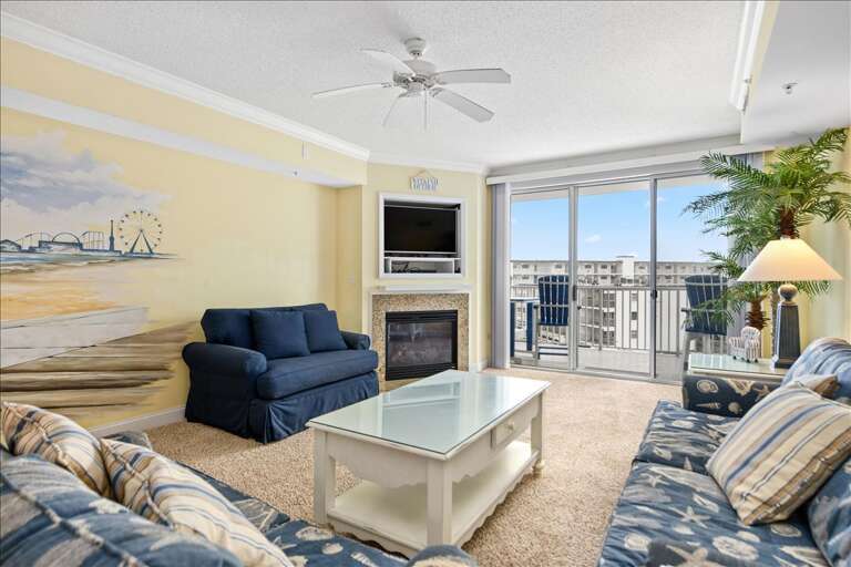 Living Room With Balcony View, Plush Sofas And A Fireplace