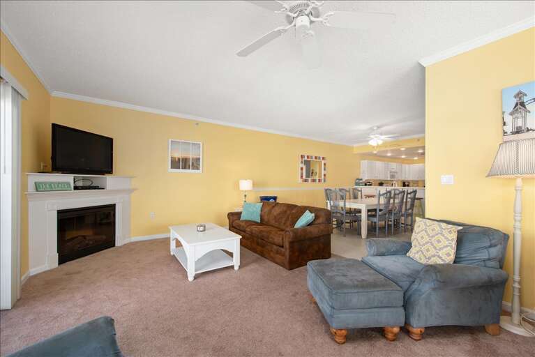 Bright, Sunlit Living Space With Plush Seats And Fireplace In Vacation Rental