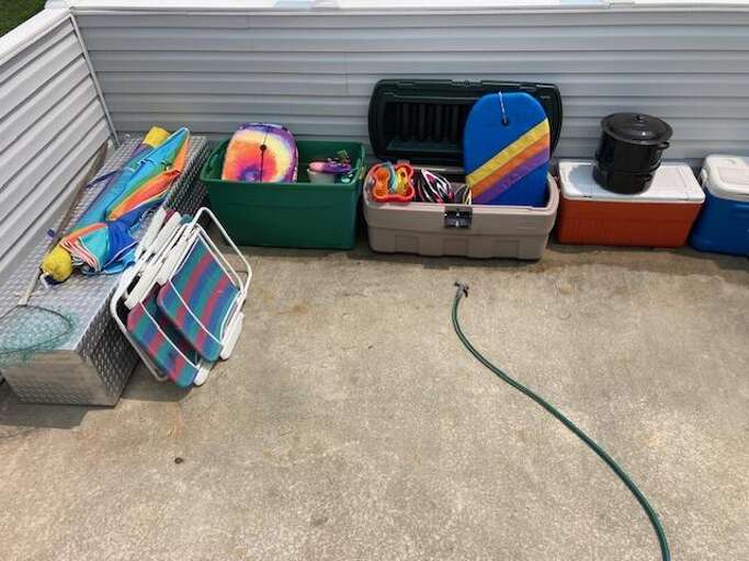 Vacation Gear Lined Along A Gray Garage Floor