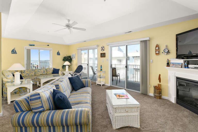 Bright Beachside Living Room Leading To Balcony With Ocean View
