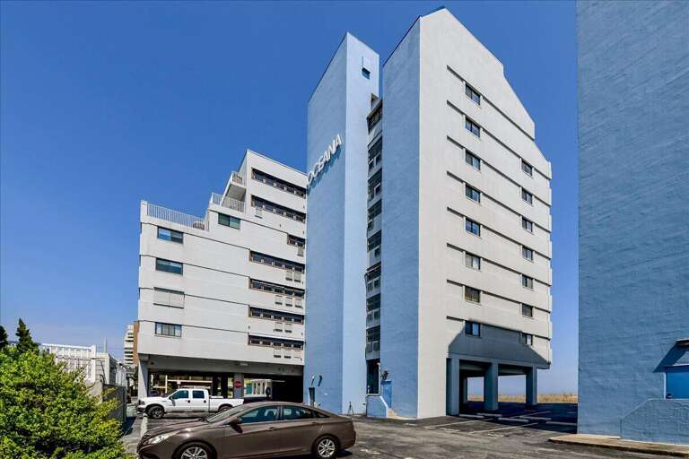 Multi-story Blue Building Bathed In Bright Sunlight