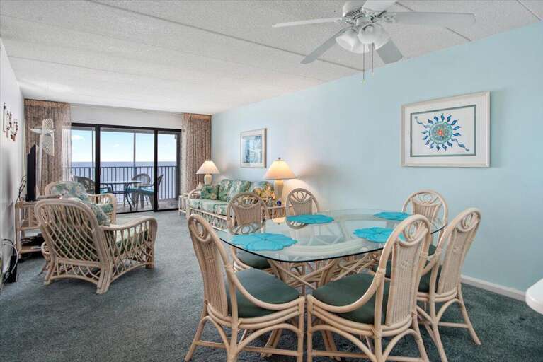 Light Blue Living Room With Rattan Furniture And Sea View
