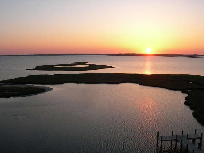 Sunset Silhouette Over Serene Sea, Shoreline Shapes Shifting