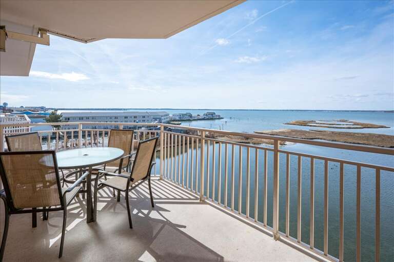 Balcony View Of Beach And Boats From A Vacation Rental