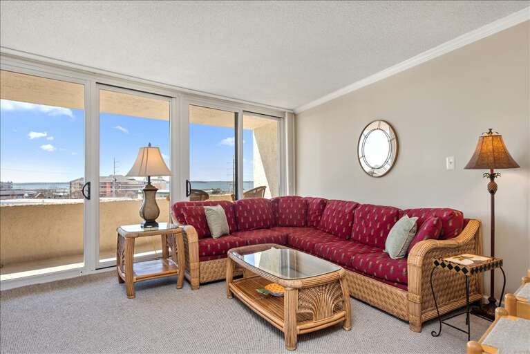 Sunlit Seating, Spacious Scene Showing Sprawling Sofa And Seaside Sights