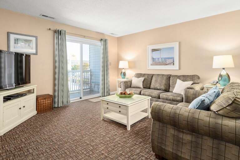 Living Room Lit By Balcony Light, Plush Sofas And Patterned Rug