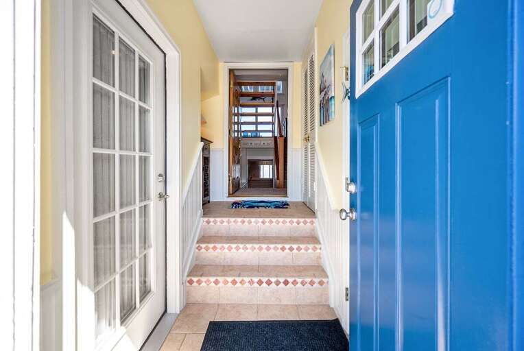 Bright Blue Doors, Sunlit Staircase Inside Building