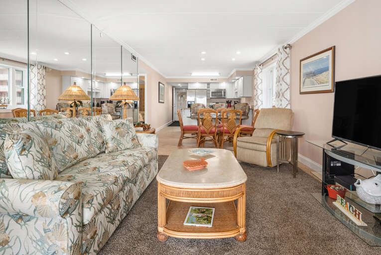 Spacious Living Room In A Vacation Rental With Floral Sofa And Dining Area