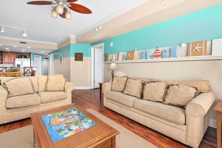 Seaside-themed Vacation Rental Living Space With Pastel Walls And Plush Seating