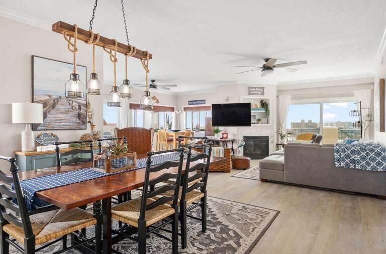Spacious Living Room With Dining Area And Balcony View In Vacation Rental