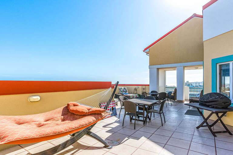 Seaside Vacation Rental Terrace With Sunbeds And Dining Set Overlooking The Ocean