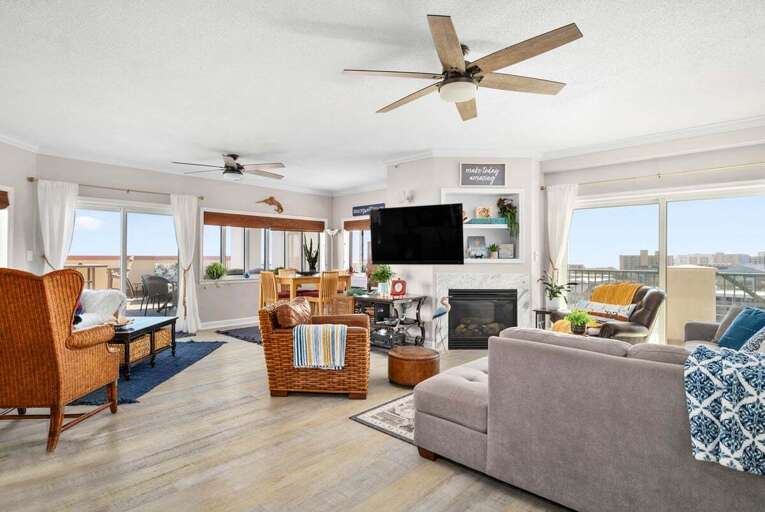 Brightly Lit Living Space With Views, Vintage Furnishings, And A Ceiling Fan