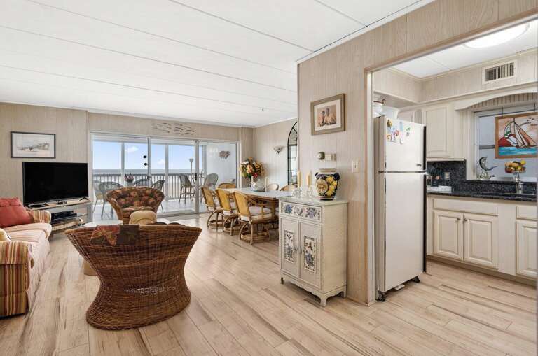 Interior View Showing Kitchen Near Spacious Seating By Seaside Window