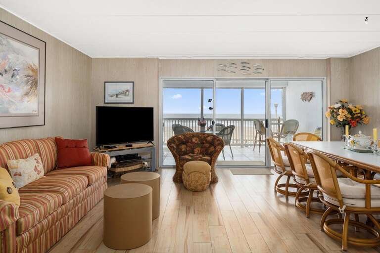 Beachfront Living Room Leading To Balcony, Bright And Breezy Ambiance With Seaside Seating