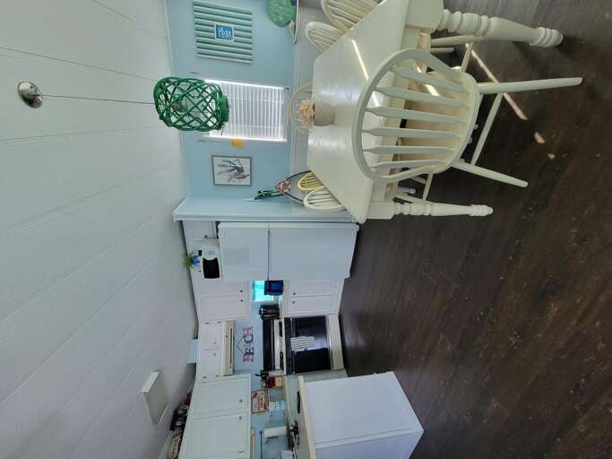 Bright, Spacious Kitchen Space With White Furniture And Appliances