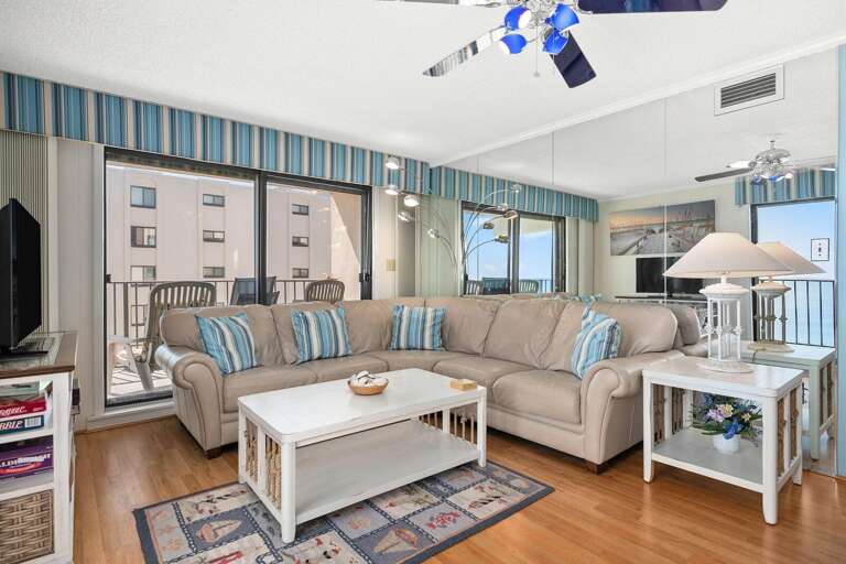 Bright Beachside Living Room With Sliding Glass Doors And Seaside Decor
