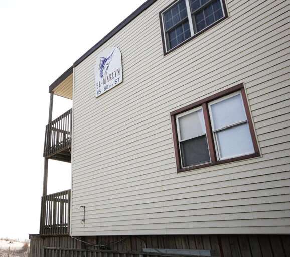 Buildings Beige Side Beneath Balconies, Bright Sign Displayed