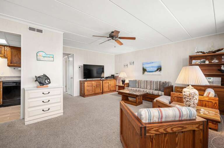 Spacious Living Area With Plush Seating And TV In Vacation Rental