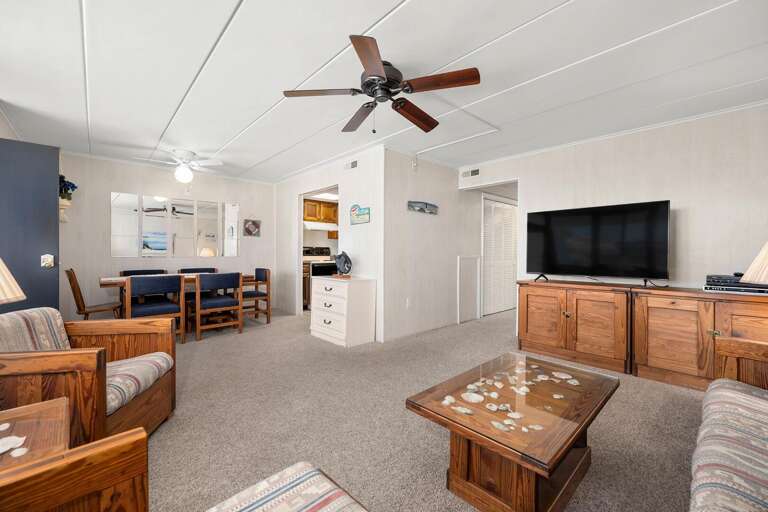 Spacious Living Room With Brown Furniture And Large TV