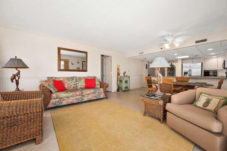 Spacious Living Room With Sofa, Lamps, And Kitchen View