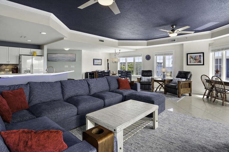 Spacious Living Space With Sprawling Sofas, Sleek Surfaces, And Serene Setting