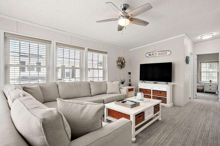 Bright, Breezy Living Room In Vacation Rental With Large Sofa Facing Flat-screen TV