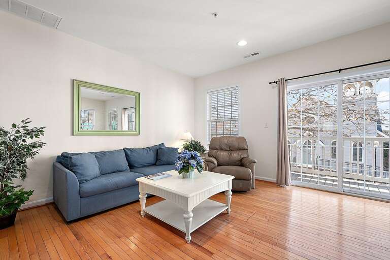 Bright Living Space, Blue Sofa, And Balcony View