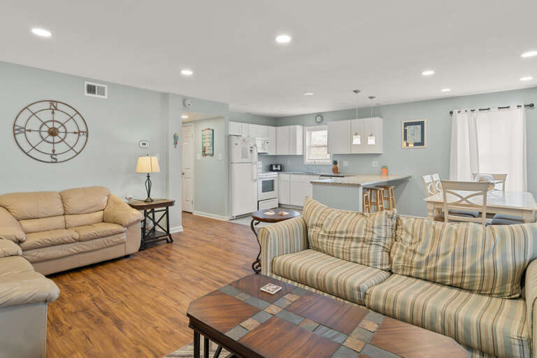 Spacious Sitting Space Sweeps Seamlessly Into Simple Kitchen Setting