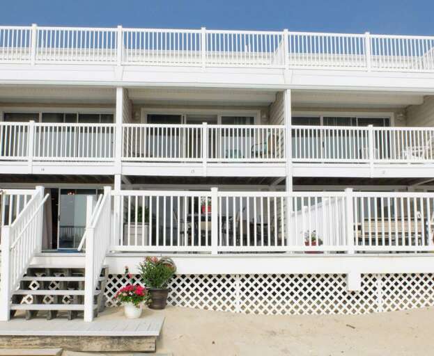 White Multi-level Vacation Rental With Balconies And Stairs