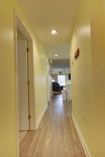 Yellow-lit Hallway Leading To A Leisurely Living Area