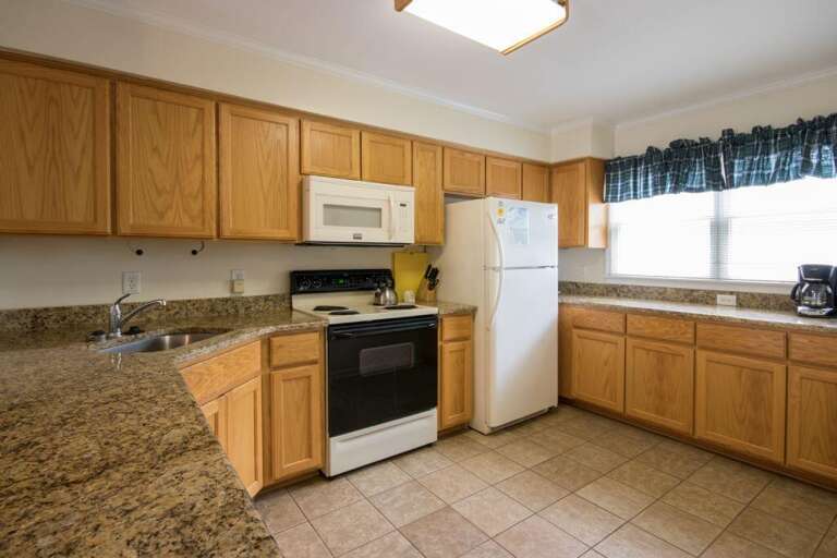 Bright, Basic Kitchen With Beige Cabinets, Built-in Oven