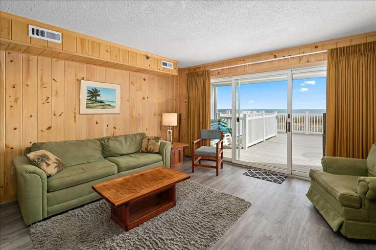 Seaside Living Room With Sliding Doors Leading To Balcony