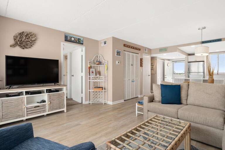 Bright Beach-themed Living Space With Streamlined Furnishings, Subtle Sea Shades, And Serene Setting