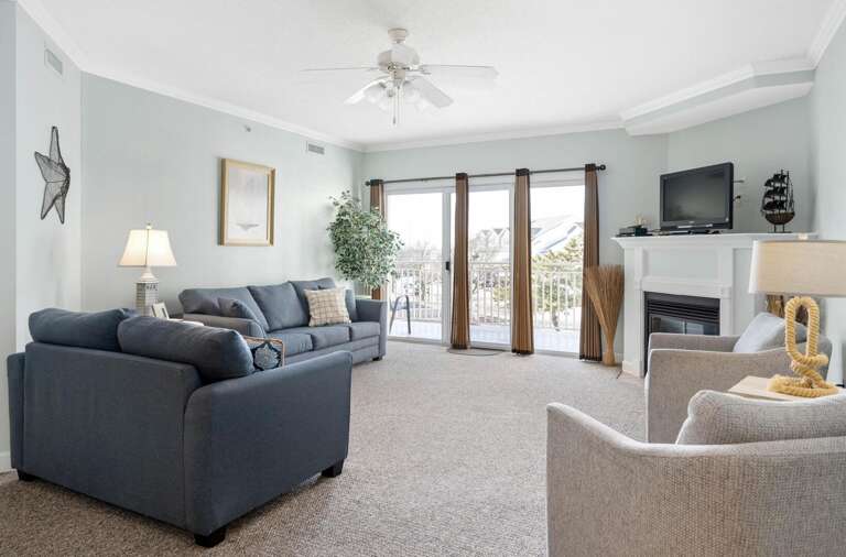 Vacation Rental Living Area With Sofas, Television, And Balcony Access