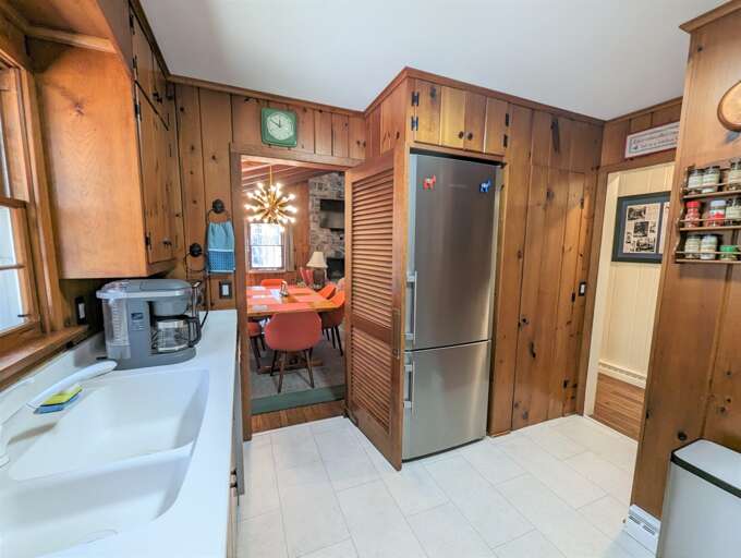 Interior Of A Kitchen With Wooden Cabinets And A Dining Area