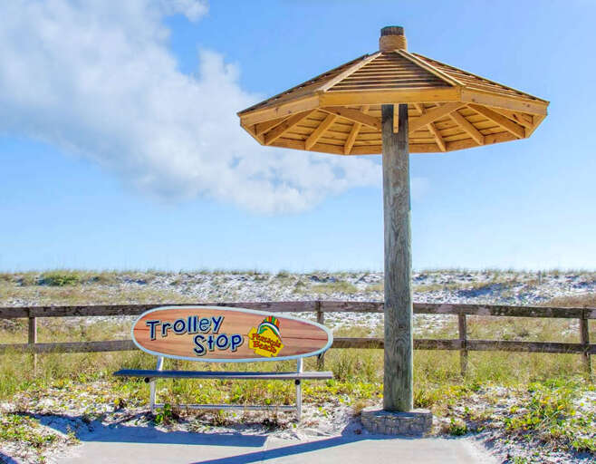 Beachside Bench Beneath Bamboo Shelter By A Trolley Stop Sign