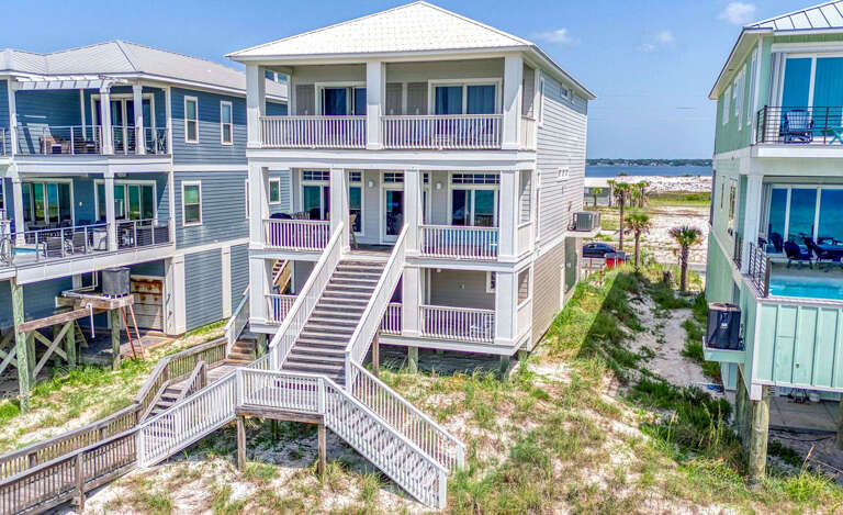 Three-tiered Beachside Buildings With Balconies, Beneath Blue Skies
