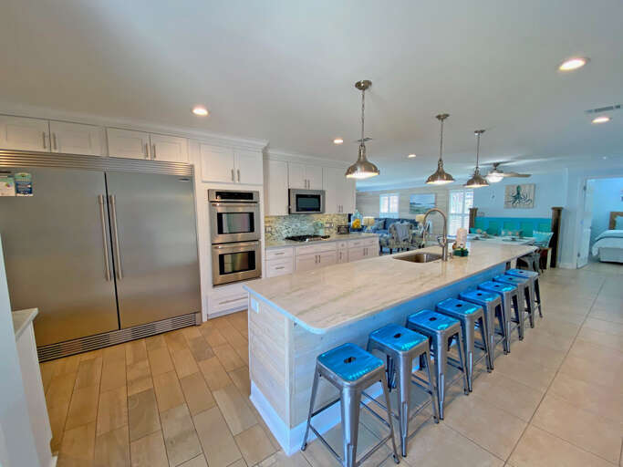 Kitchen Interior With Island And Blue Stools
