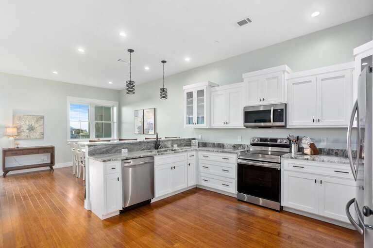 Residential Kitchen With Stainless Steel Appliances And Hardwood Floors