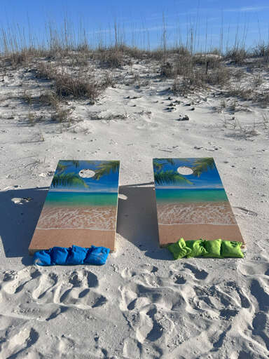 Beach Boards Beside Blue Towels On Sandy Shore