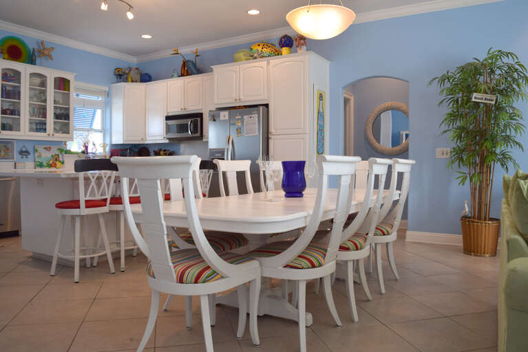 The dining table is just off of the kitchen and seats 8.