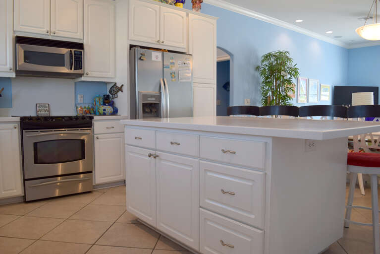 The kitchen has stainless steel appliances and large island.