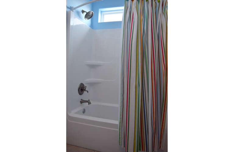 The jack and jill bath has a tub/shower combo and closes off to both bedrooms.