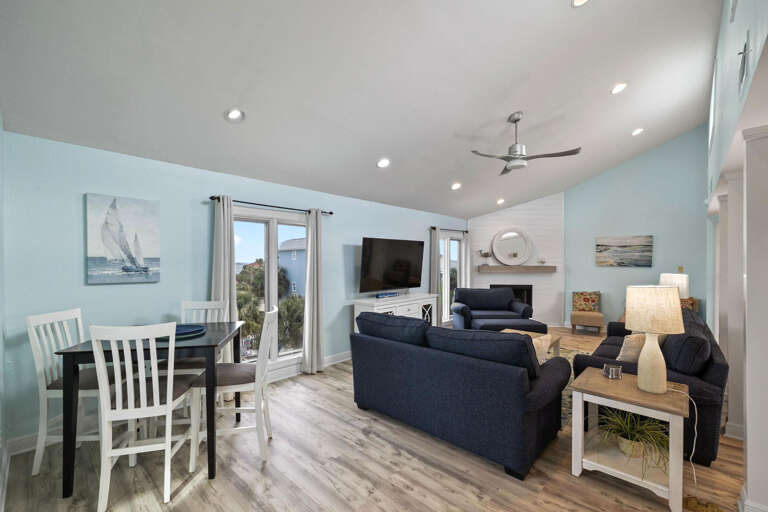 Bright Blue Living Space In A Breezy Beachside Vacation Rental With Balcony Doors