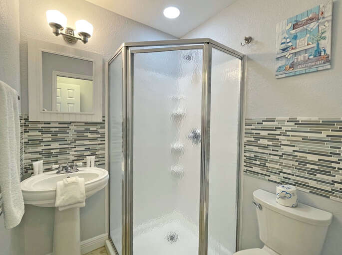 Bathroom With Shower Cubicle And Patterned Wall Tiles